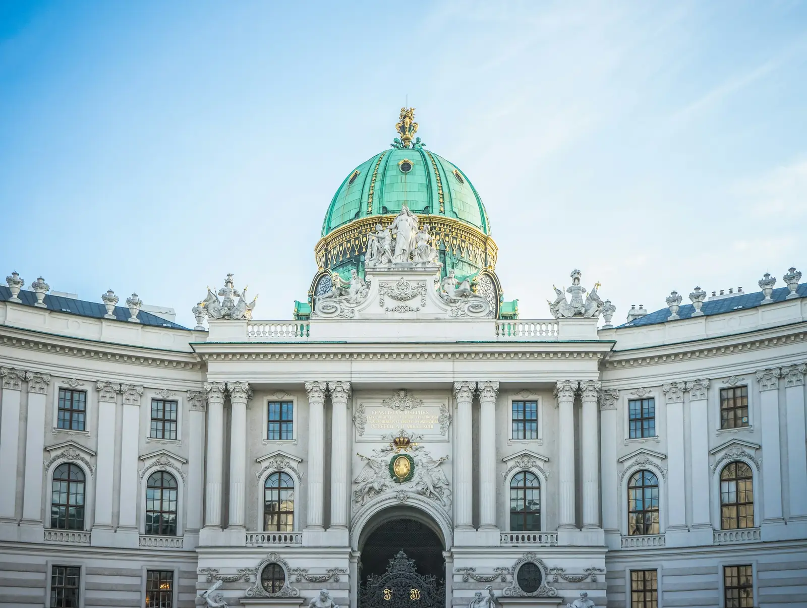 Ala Michaelertrakt del Hofburg de Viena con su cúpula verde bajo un cielo azul